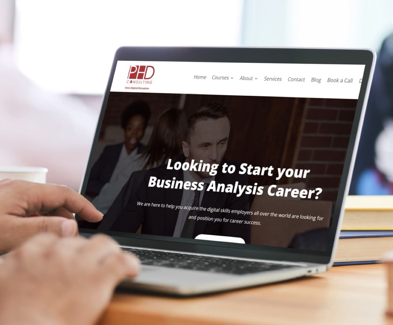 PHD Consulting website open on a laptop